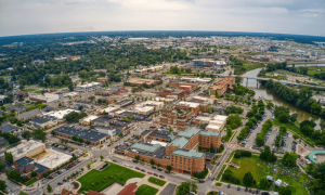 Aerial view of Midland, MI showcasing downtown area, residential buildings, and green spaces, relevant to real estate insights and community resources.
